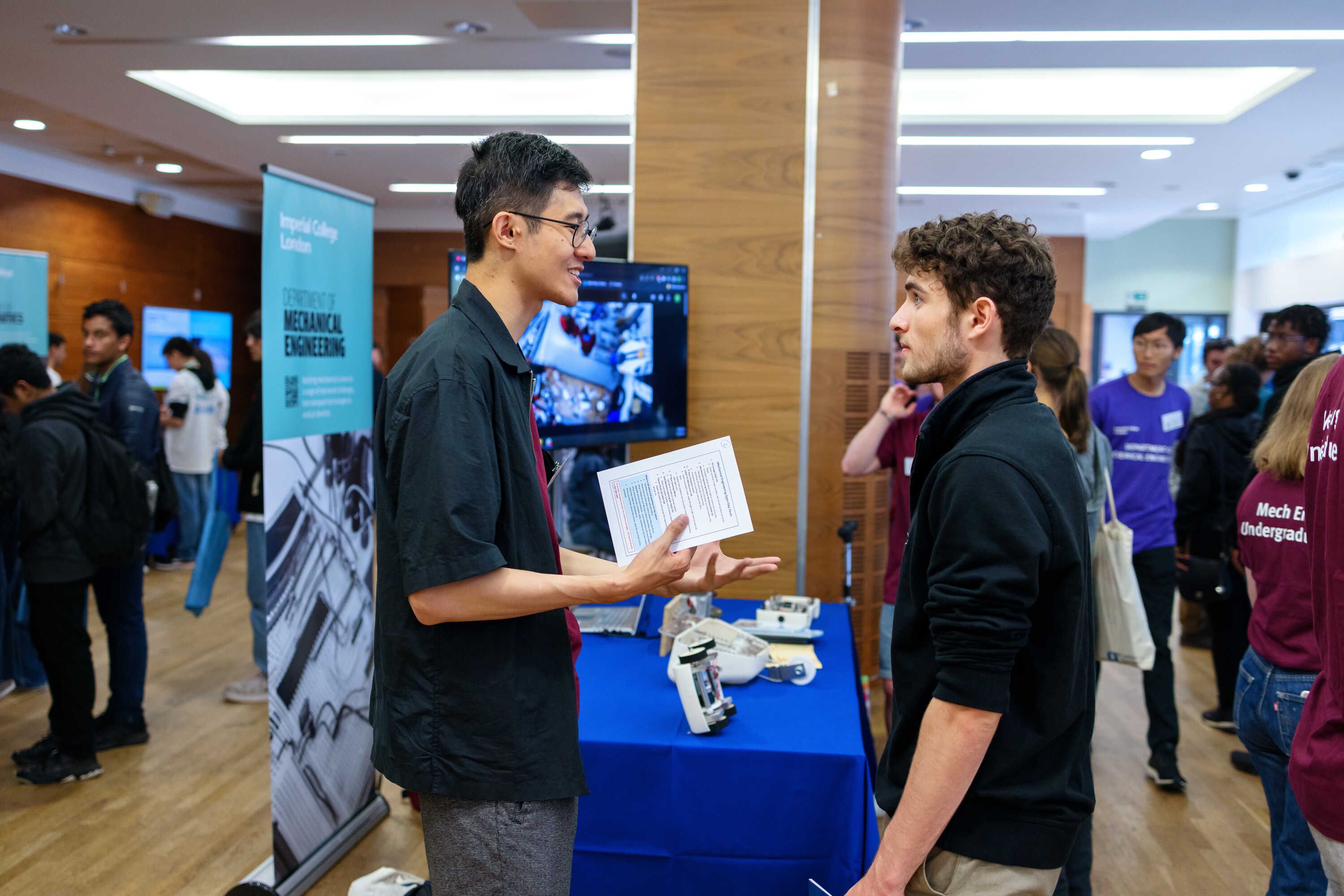 Two students talking at an event at Imperial's South Kensington Campus