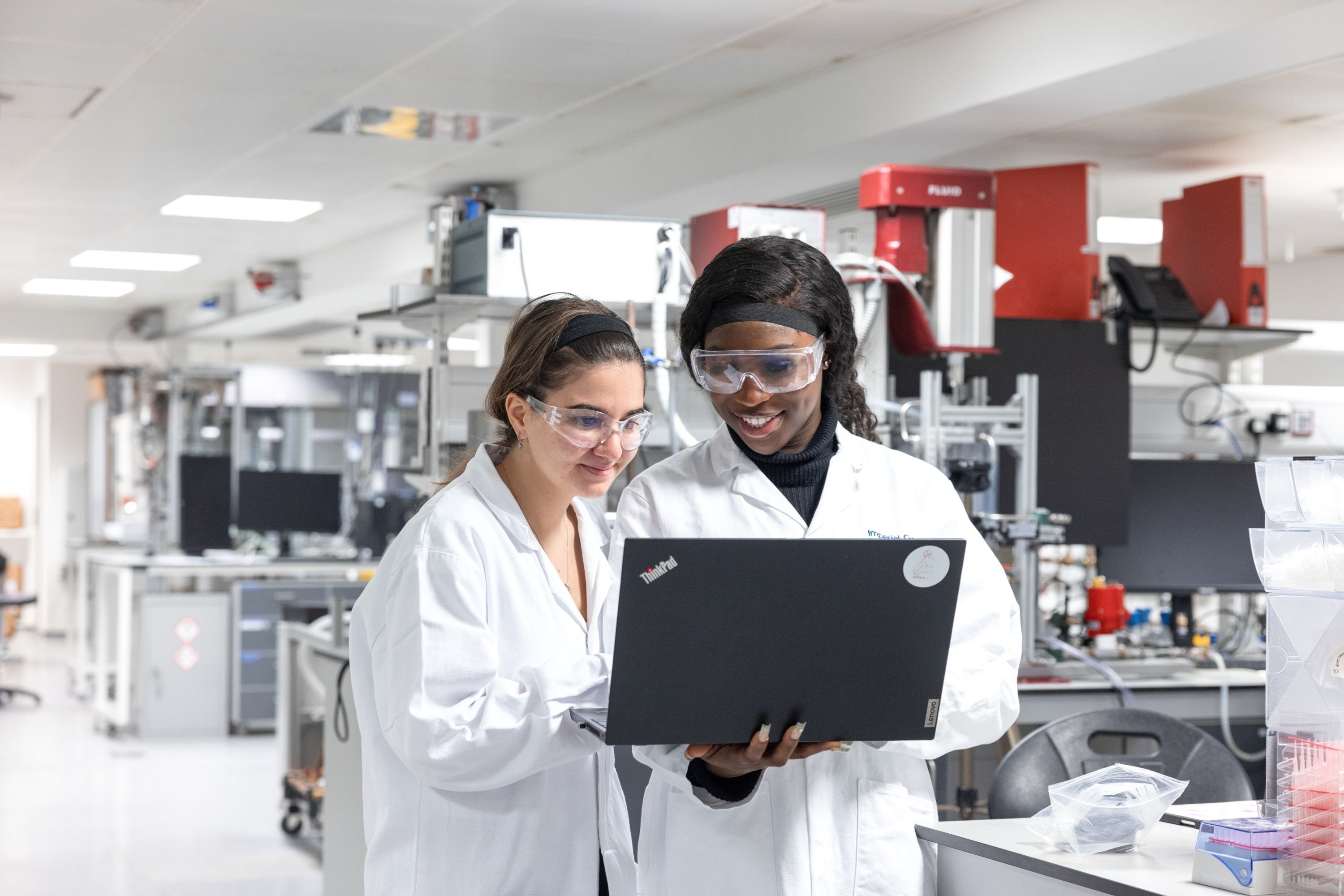 Two students in the lab on a laptop