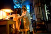 Materials researchers working with molten glass wearing safety equipment, melt bioactive glass