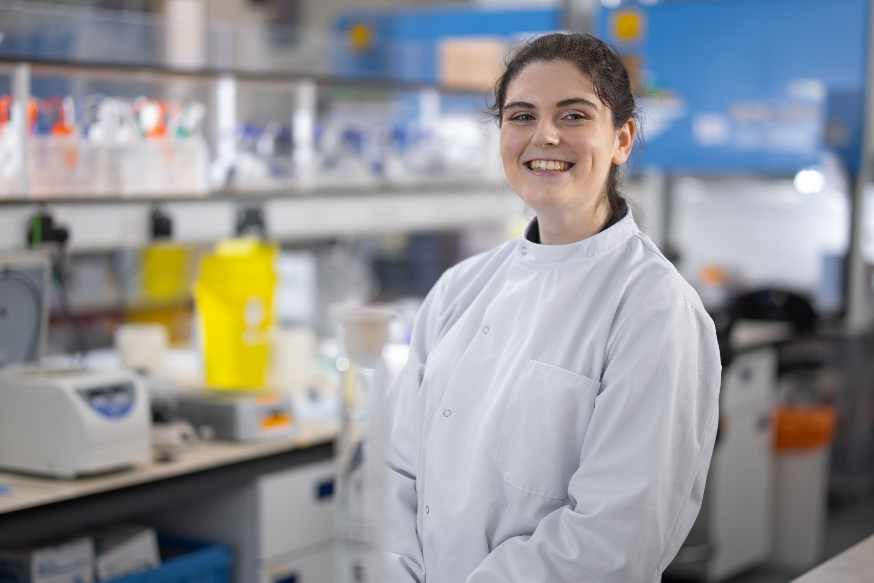 A female student smiling in a lab